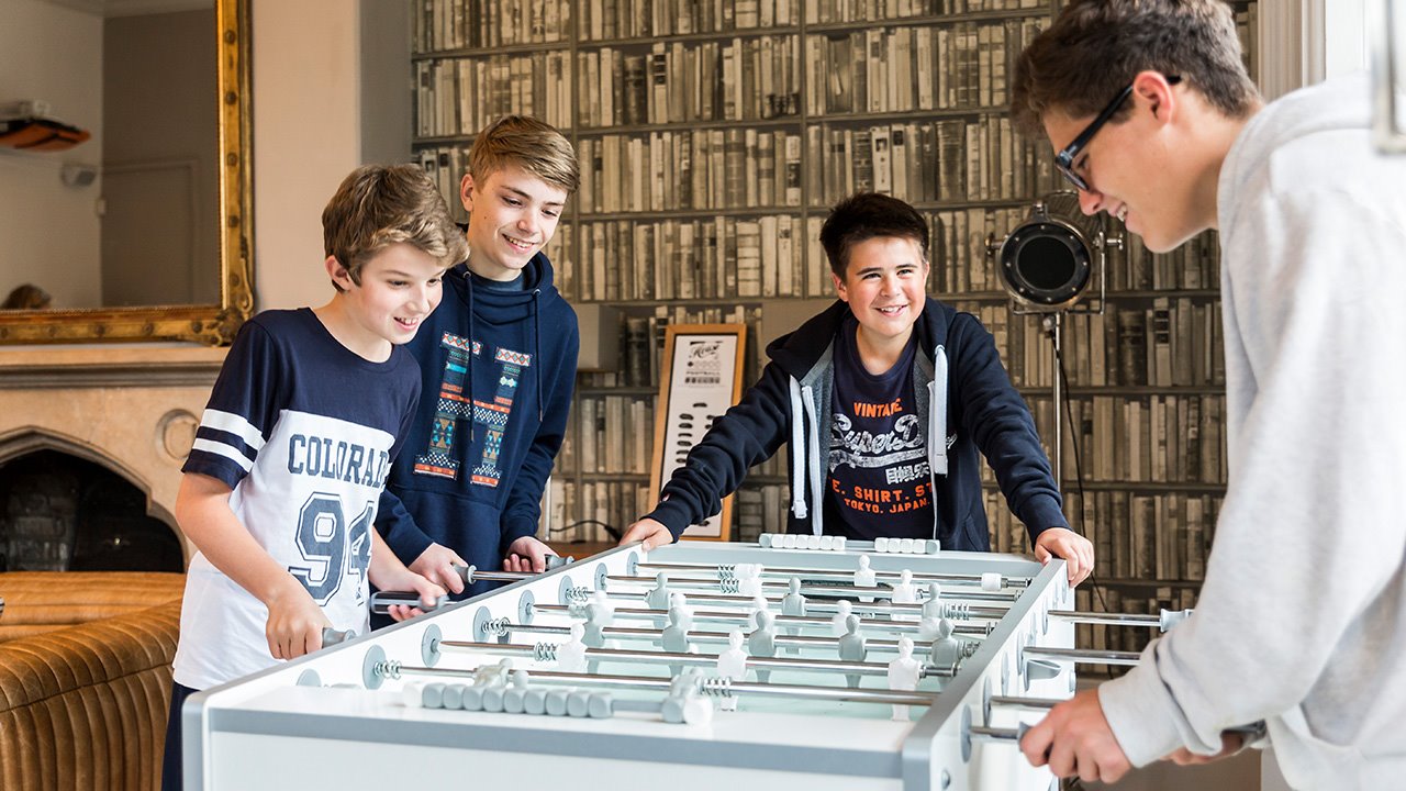 Boys-boarding-playing-table-football.jpg